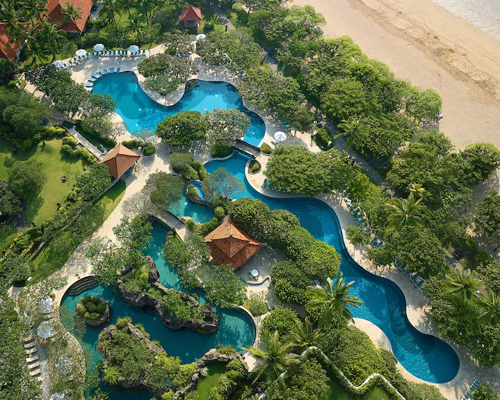 Garden River Pool at Grand Hyatt Bali winding through tropical landscaping